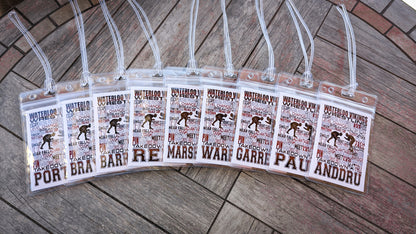 Personalized Waterloo Vikings wrestling team bag tags arranged in a fan, each in a clear holder with a loop strap and individual name.